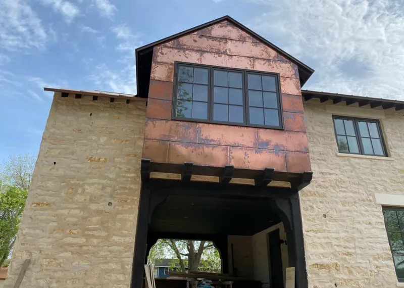 Copper metal panel facade on a stone building for Skylight Installation in La Grande